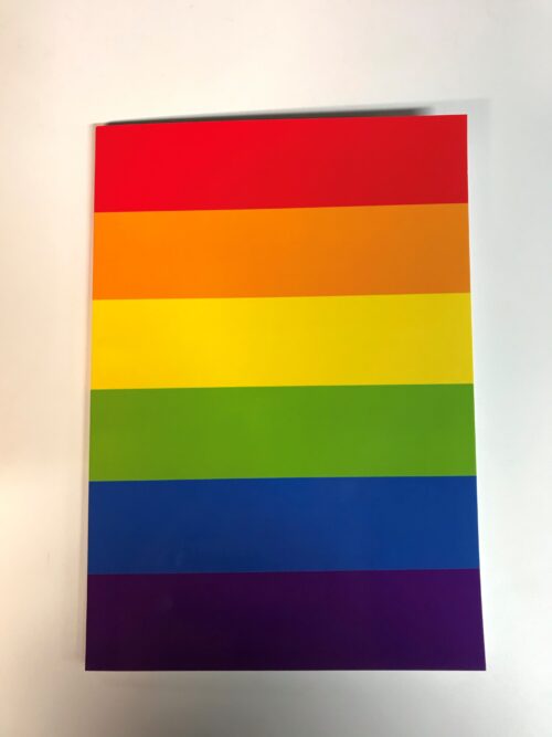 image shows a notebook with cover in rainbow flag colours